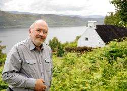 Tony Harmsworth outside his home by Loch Ness