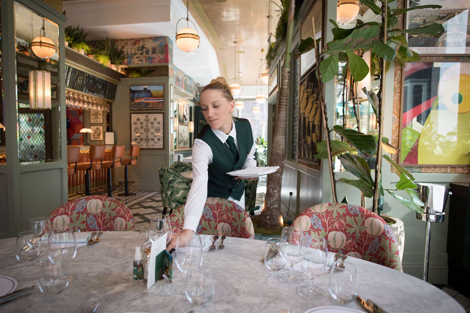 Staff at the Ivy Victoria in London prepare the dining area ahead of the final day of Eat Out to Help Out (Stefan Rousseau/PA)