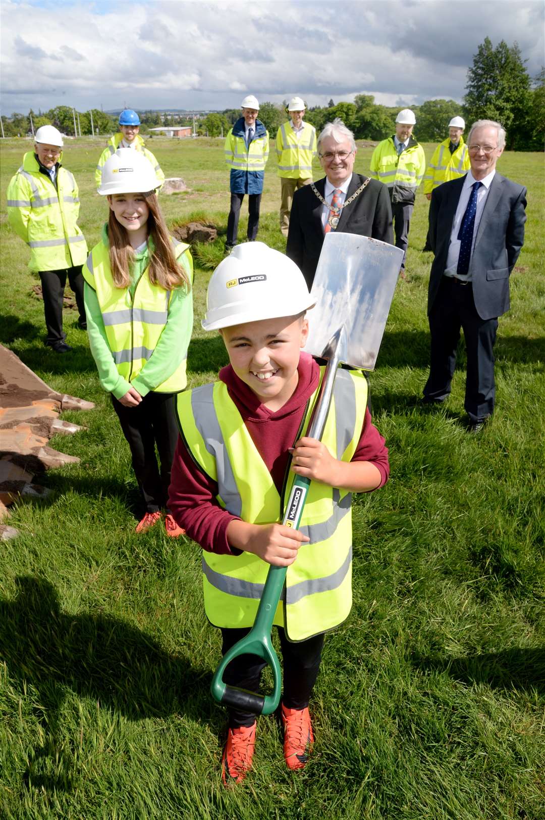 At the sod cutting to mark the start of the second stage of the West Link Road there were two special guests. Kinmylies Primary school house captains Reece Fraser and Emily Mackenzie helped start the digging along with Inverness Depute Provost Graham Ross and Councillor Allan Henderson. Also pictured are members of the project team from RJ Mcleod and Highland Council...Picture: Gair Fraser. Image No. 044088.