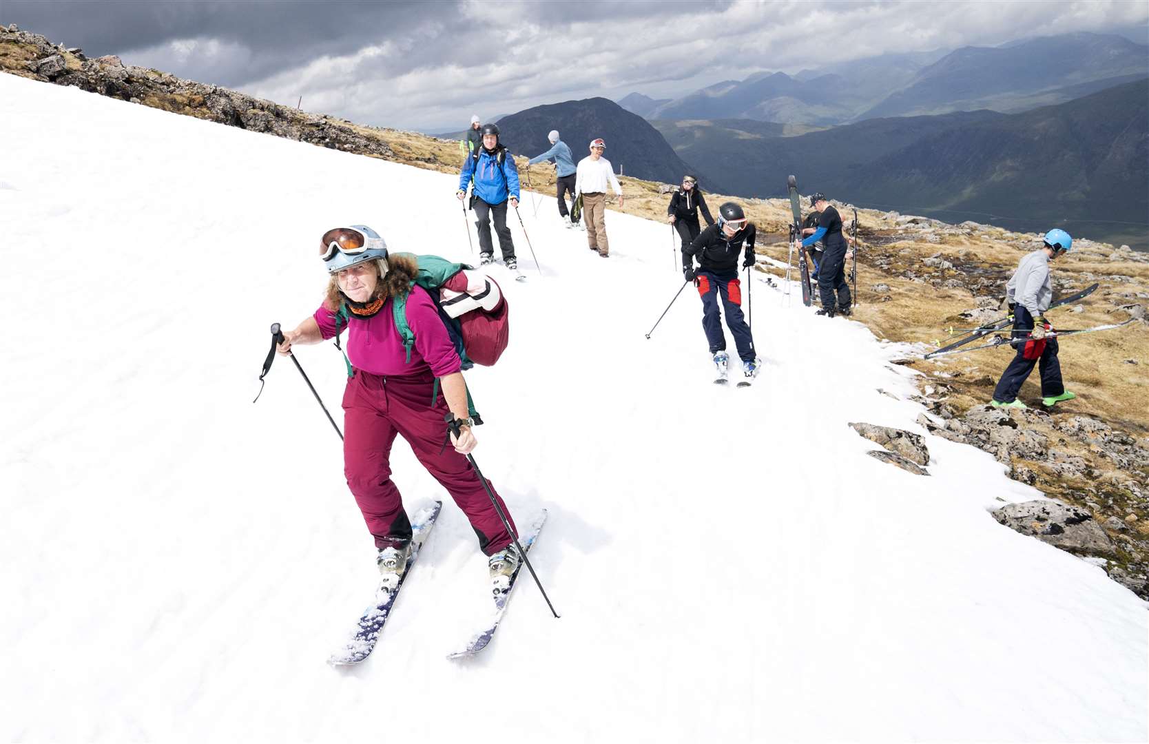 Joyce Paton, from Peterhead, on one of the remaining snow patches on Meall a’Bhuiridh in Glencoe during the Midsummer Ski event near the summer solstice (Jane Barlow/PA)