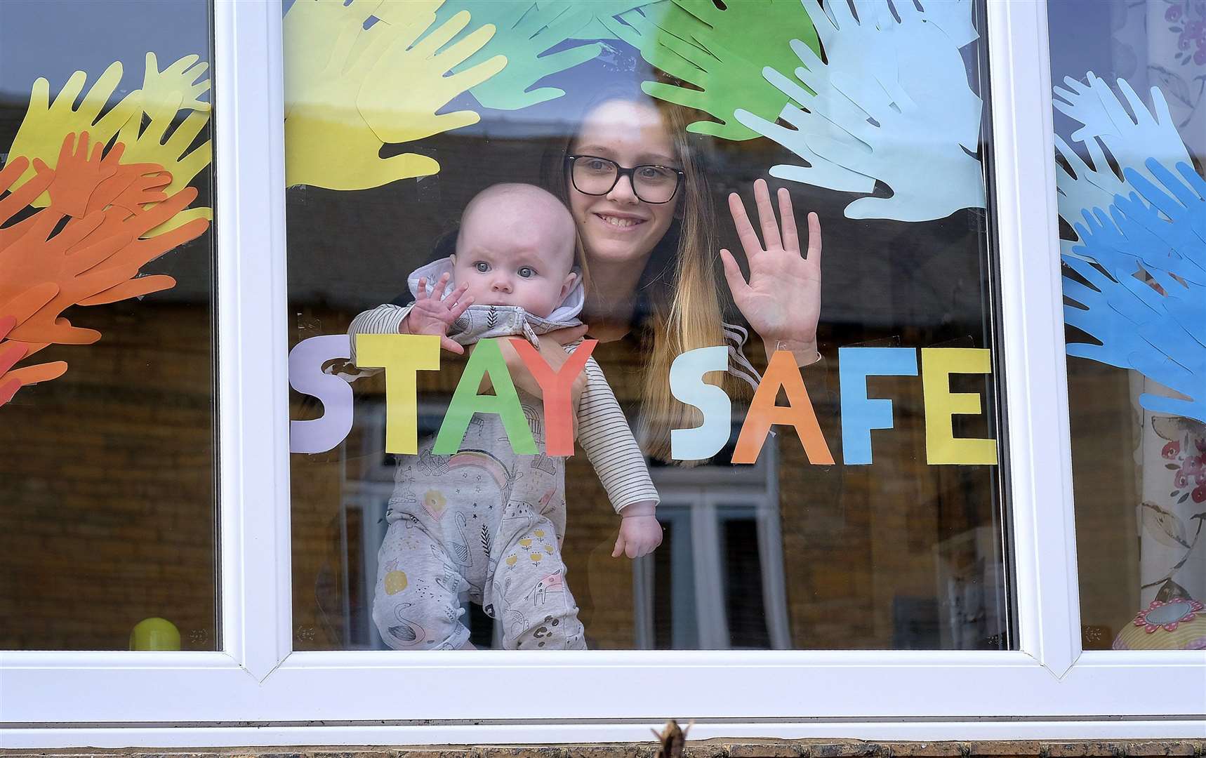 Scarborough residents place messages in their windows Neavie and Ella Bulman look out of their window. Picture: Richard Ponter