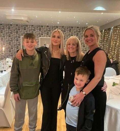 Lynn (centre) and her family.
