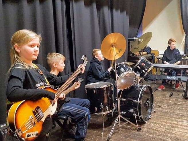 Youngsters learning to play music at RoKzKool Academy.