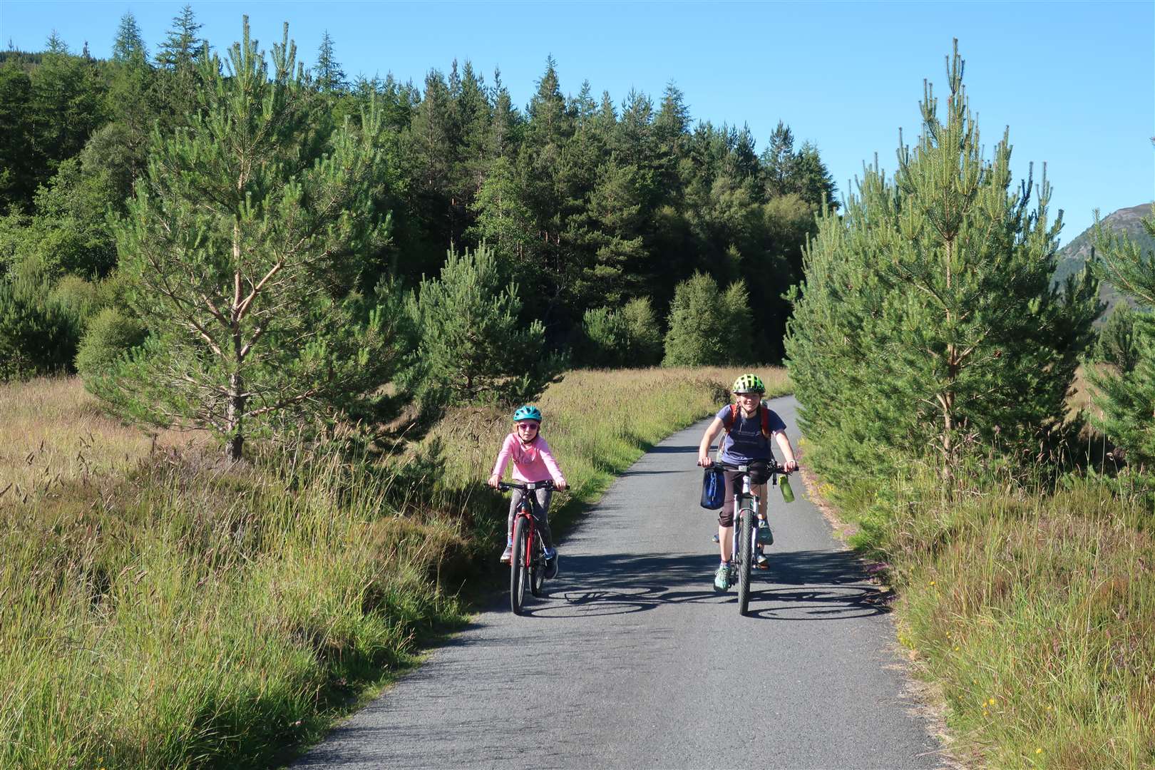 Jennifer, Meg and Matthew (out of sight on the tagalong) on the estate road in Glen Feshie.