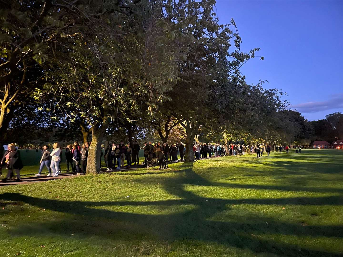 The queues grow all around the Meadows Park in Edinburgh.