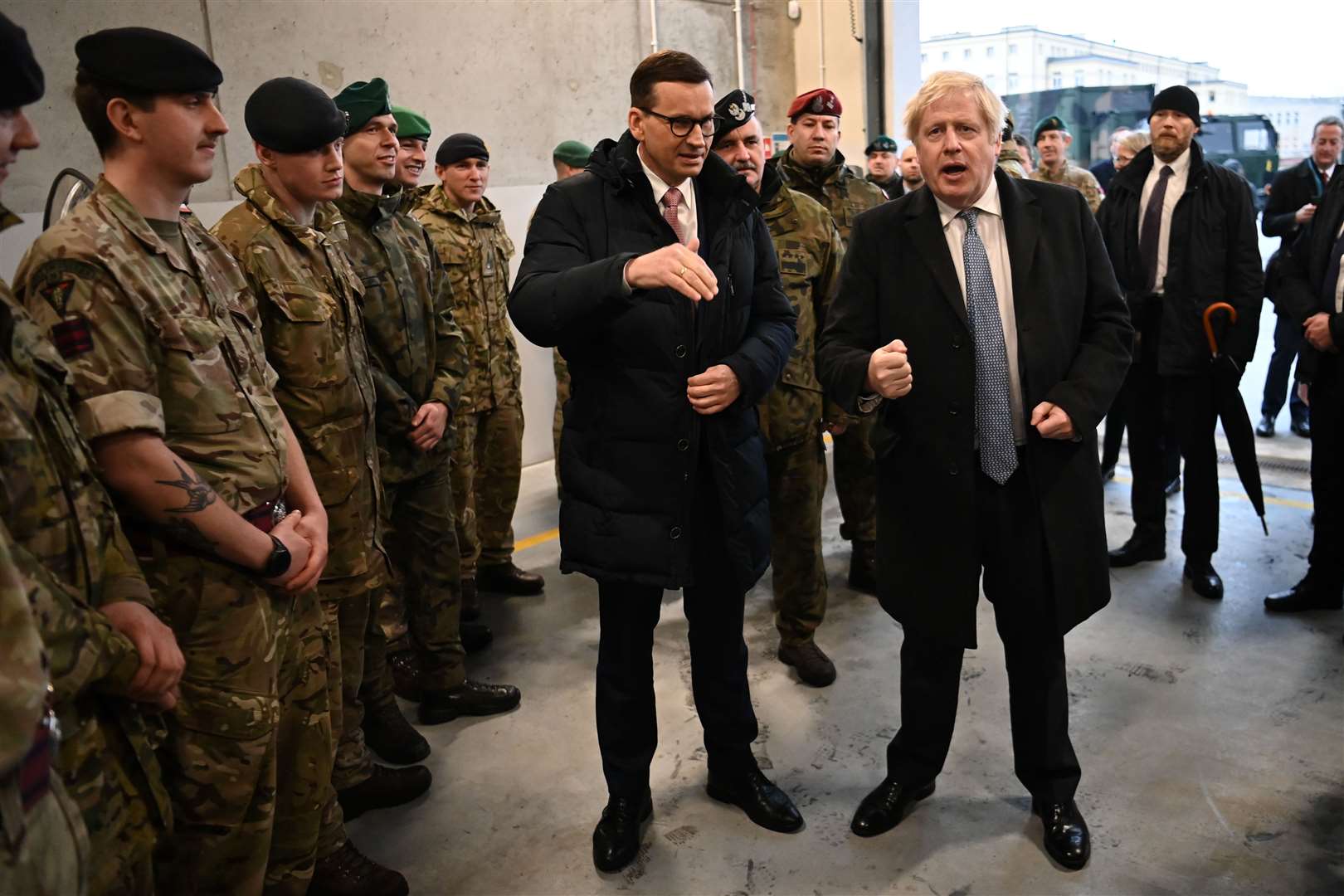 Boris Johnson gestures as he speaks to British troops during a visit with Polish Prime Minister Mateusz Morawiecki to a military base in Warsaw (Daniel Leal/PA)