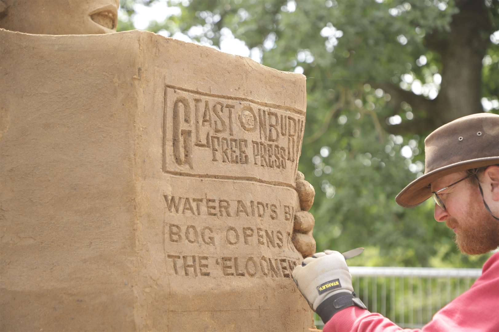 Artists Sand In Your Eye spent more than 40 hours carving Worthy Farm’s biggest WC, which is located near the Pyramid Stage (WaterAid/Sand In Your Eye)