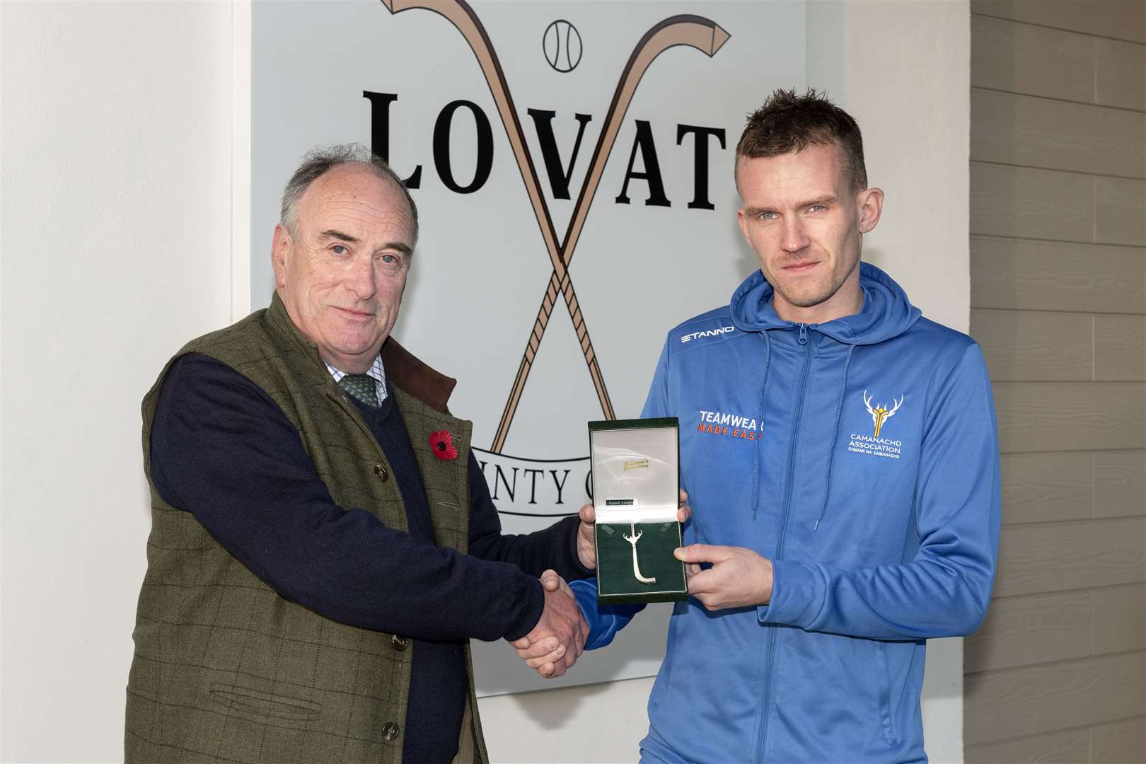 Stuart Macdonald receives the silver kilt pin from Michael Campbell.