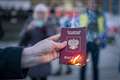 Campaigner burns Russian passport as hundreds gather for Ukraine vigil