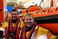 RNLI crew members celebrate after passing helm assessments