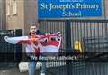 Man holding Ulster flag outside Catholic primary school condemned by social media users 