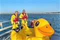 Three people rescued after giant inflatable duck drifts out to sea
