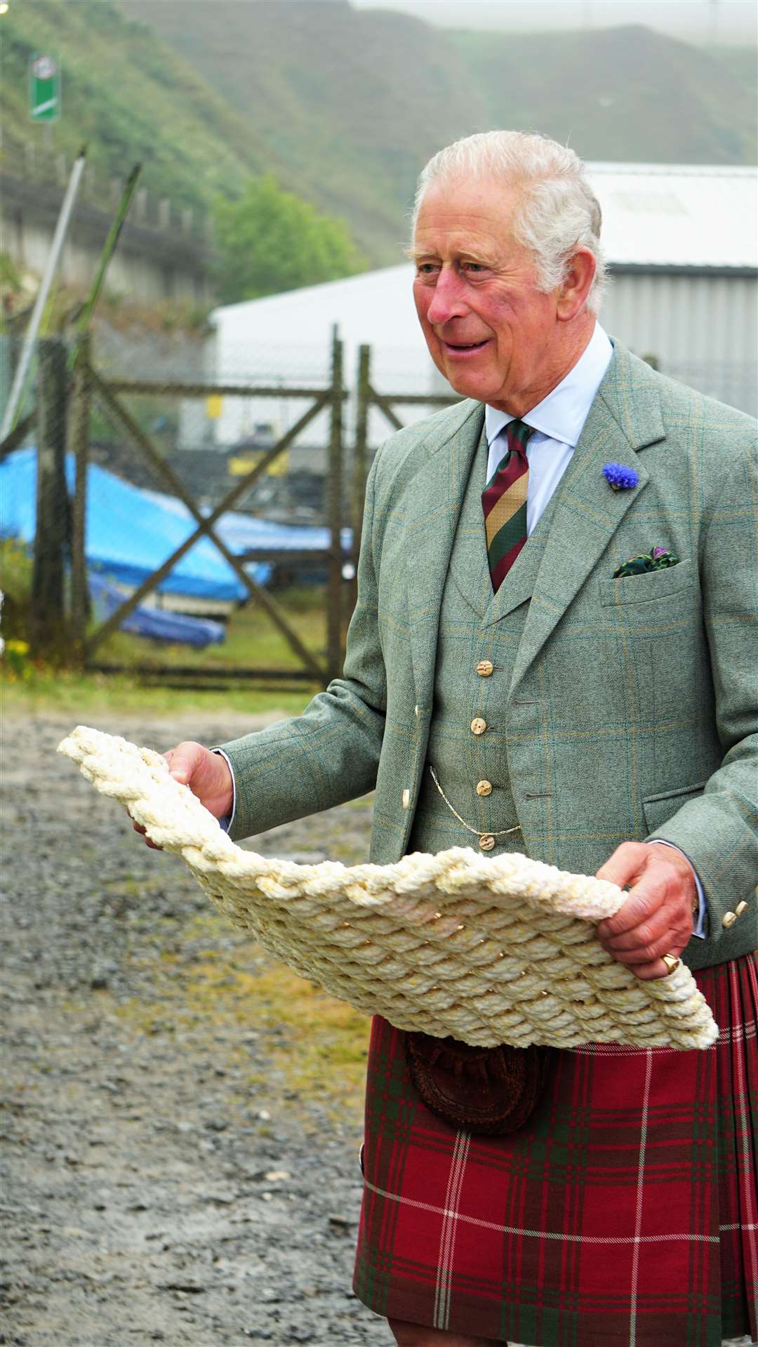 Prince Charles with a mat made from recycled fishing rope.