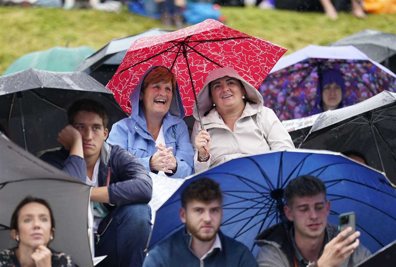 Spectators watching in the rain on Friday (Andrew Matthews/PA)