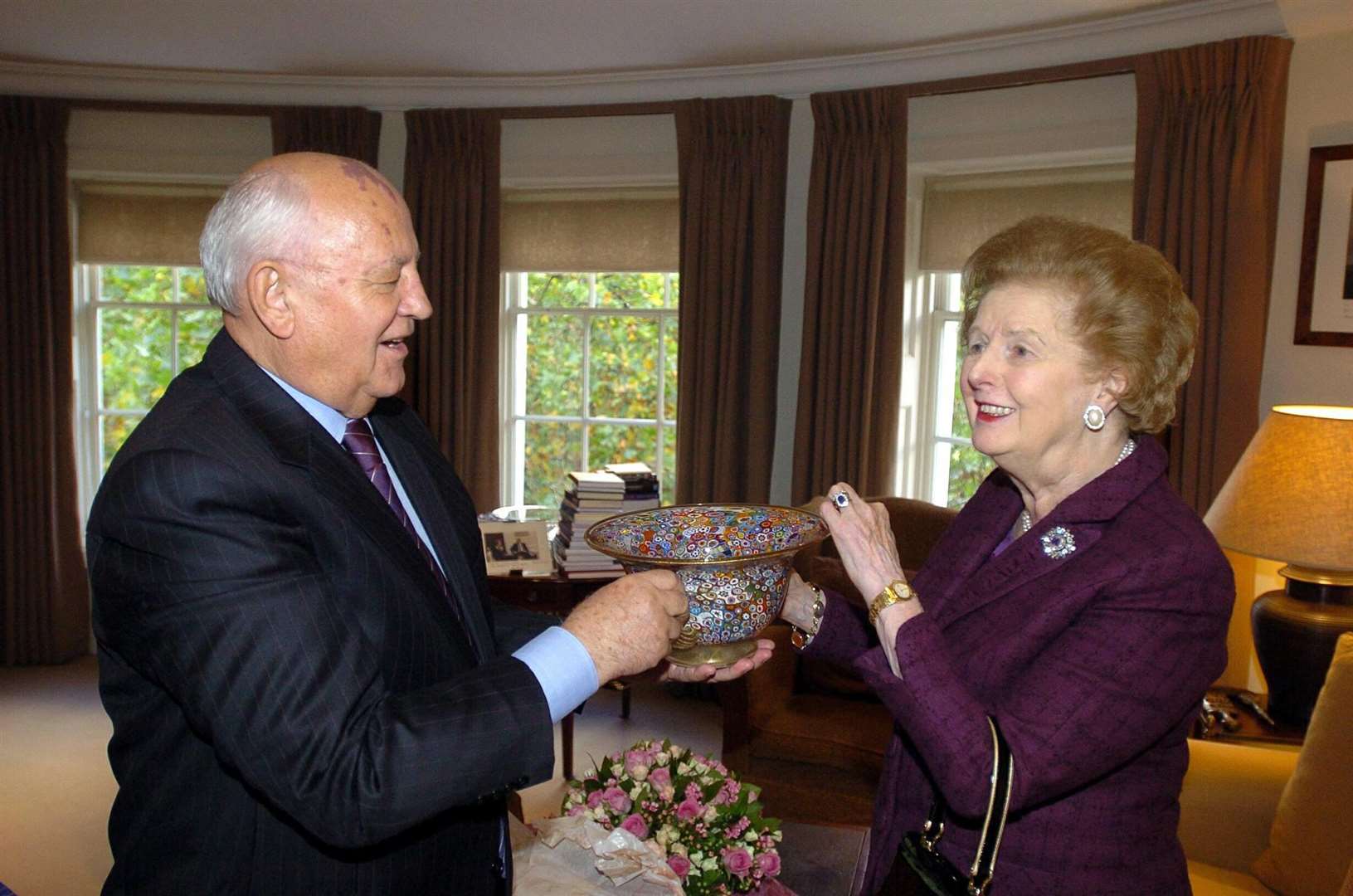 Mikhail Gorbachev presents Lady Thatcher with glass bowl at a meeting in October 2005 (Michael Stephens/PA)