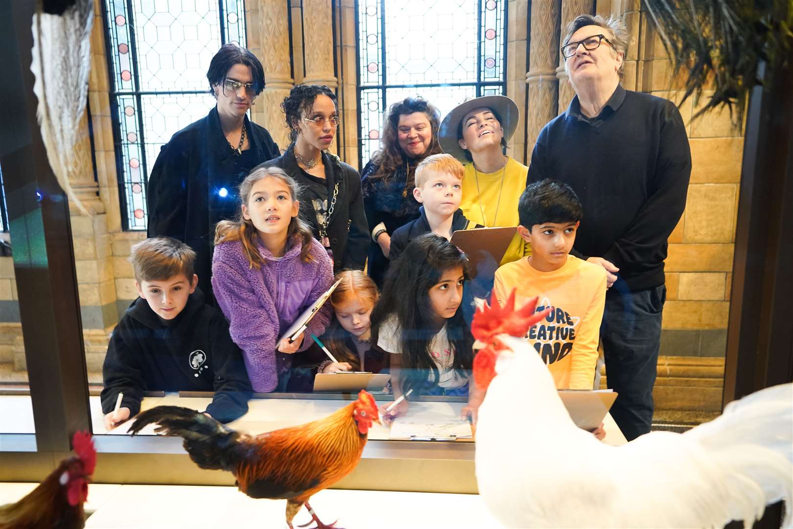 FKA Twigs, Mark Wallinger and artist Es Devlin help children with drawings at the Natural History Museum in London (James Manning/PA)
