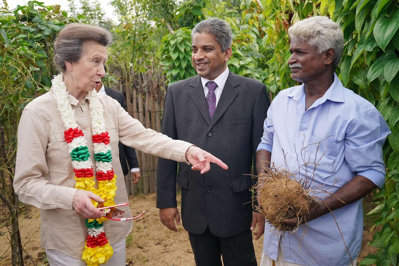 The Princess Royal is shown a purple yam as she visits a resettlement village at the Halo Trust site in Muhamalai (Jonathan Brady/PA)