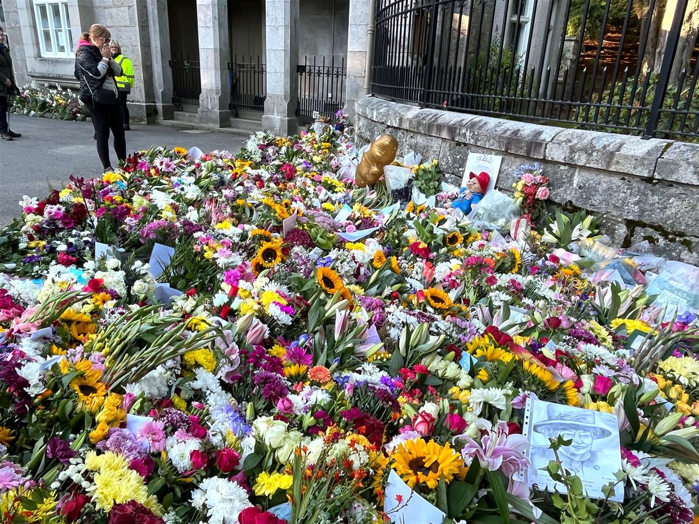 Bouquets of flowers have been laid outside Balmoral Castle, where the Queen died (Tom Wilkinson/PA)