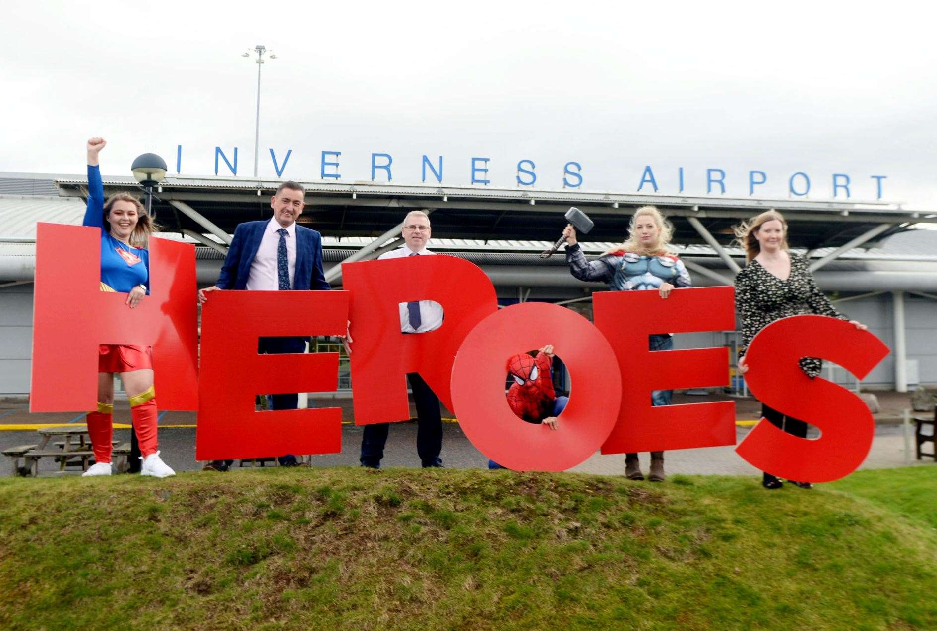 Graeme Bell, Inverness Airport general manager, Davie Geddes, terminal operations manager and Cheryl Campbell, airport services manager, and super friends, launched Highland Heroes 2022. Picture: James Mackenzie