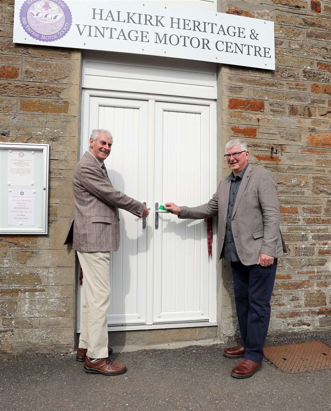 Edward Sutherland's cousins Alasdair and Iain Sutherland cut the ribbon to open the Halkirk Heritage and Vintage Motor Centre on Saturday. Picture: James Gunn