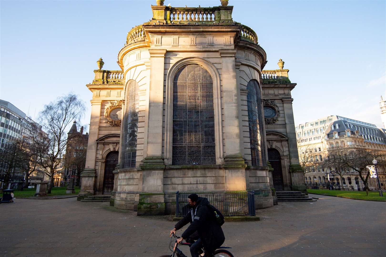 A cyclist passes St Philip’s Cathedral in Birmingham – outdoor exercise is still permitted (Jacob King/PA)
