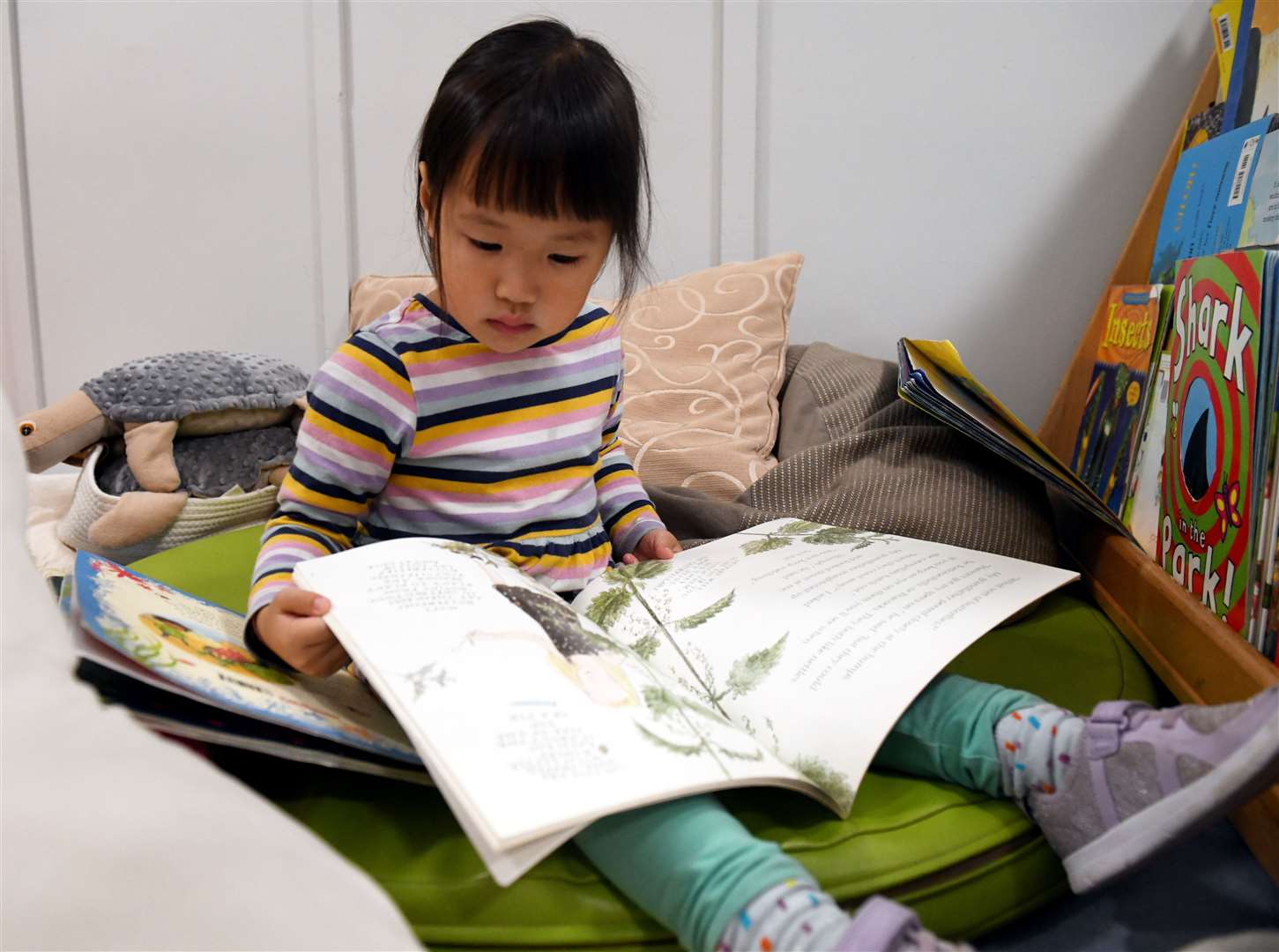 Grace Ghan has a quiet moment with a book.