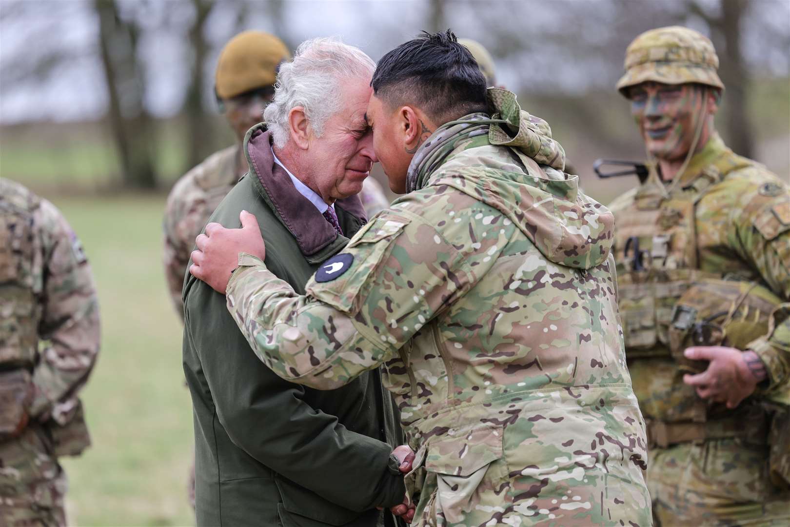 The King receives the hongi – the traditional Maori greeting – from a New Zealander who is part of the Ukrainian contingent during a visit to a training site in Wiltshire (Chris Jackson/PA)