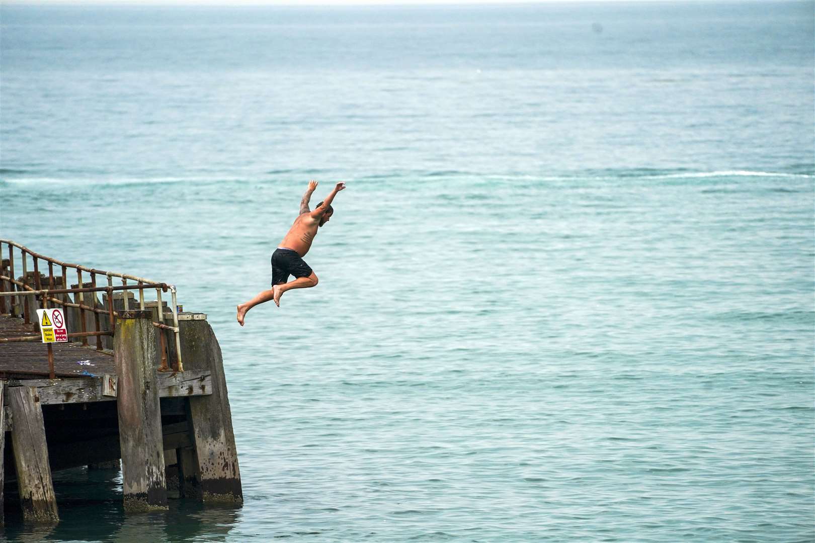 A man jumps from the pier in Bournemouth (Steve Parsons/PA)