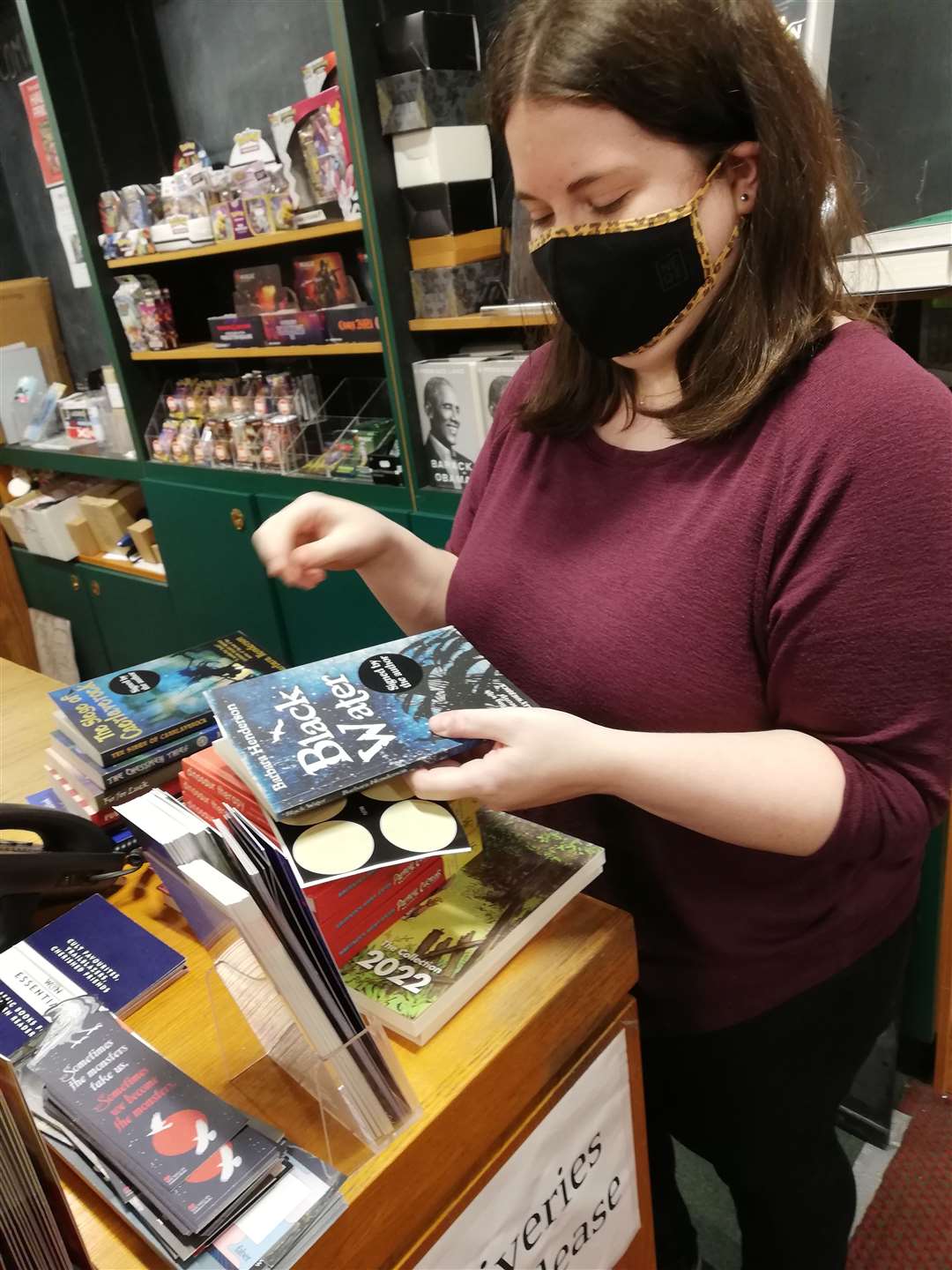 Bookseller Robyn at Waterstones in Elgin displaying Barbara's book The Black Water.