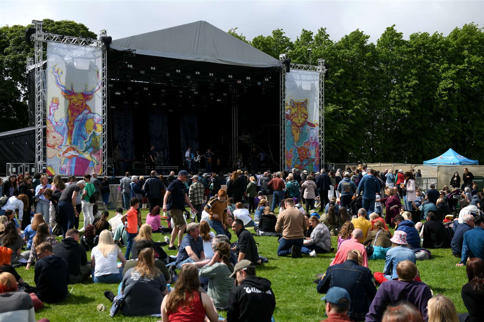 The sun shining as the crowd relaxed at the main stage.