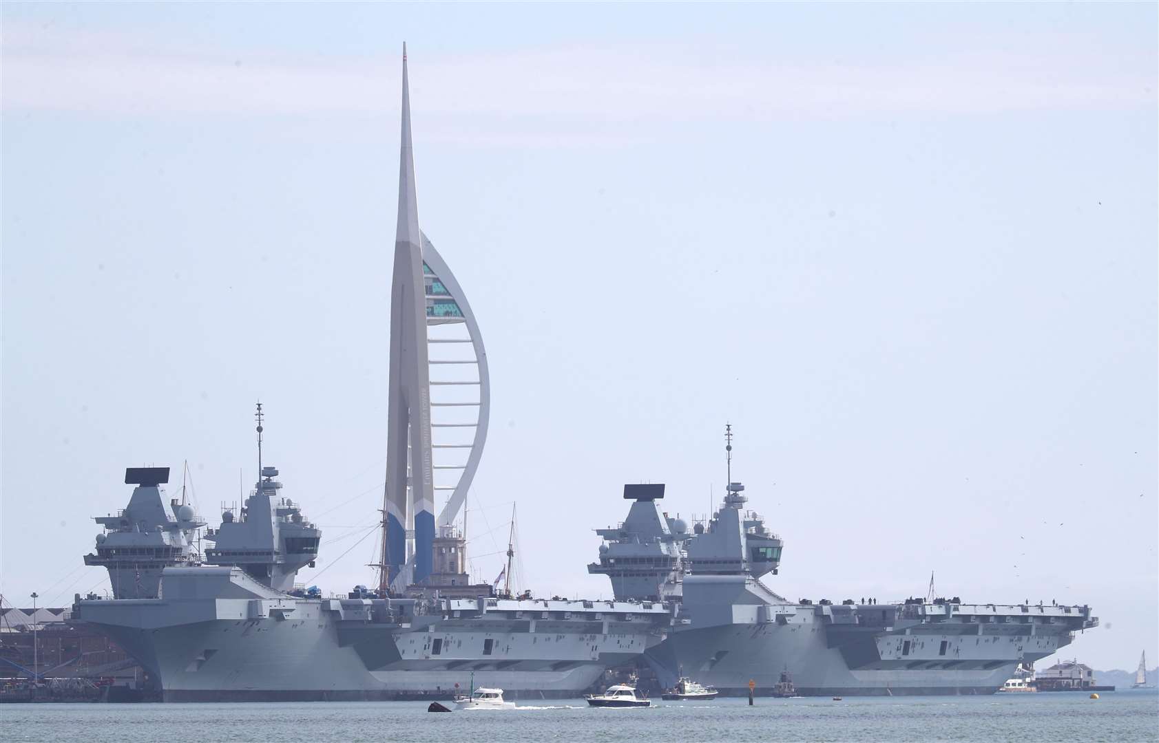The Royal Navy aircraft carriers HMS Prince of Wales (left) and HMS Queen Elizabeth moored up next to each other at HMNB Portsmouth (Andrew Matthews/PA)
