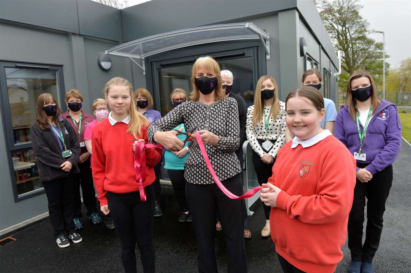 Duncan Forbes Primary pupils Sophie Shuttleworth and Sophie MacDonald help former nursery teacher Lorna MacGregor open the new nursery unit.