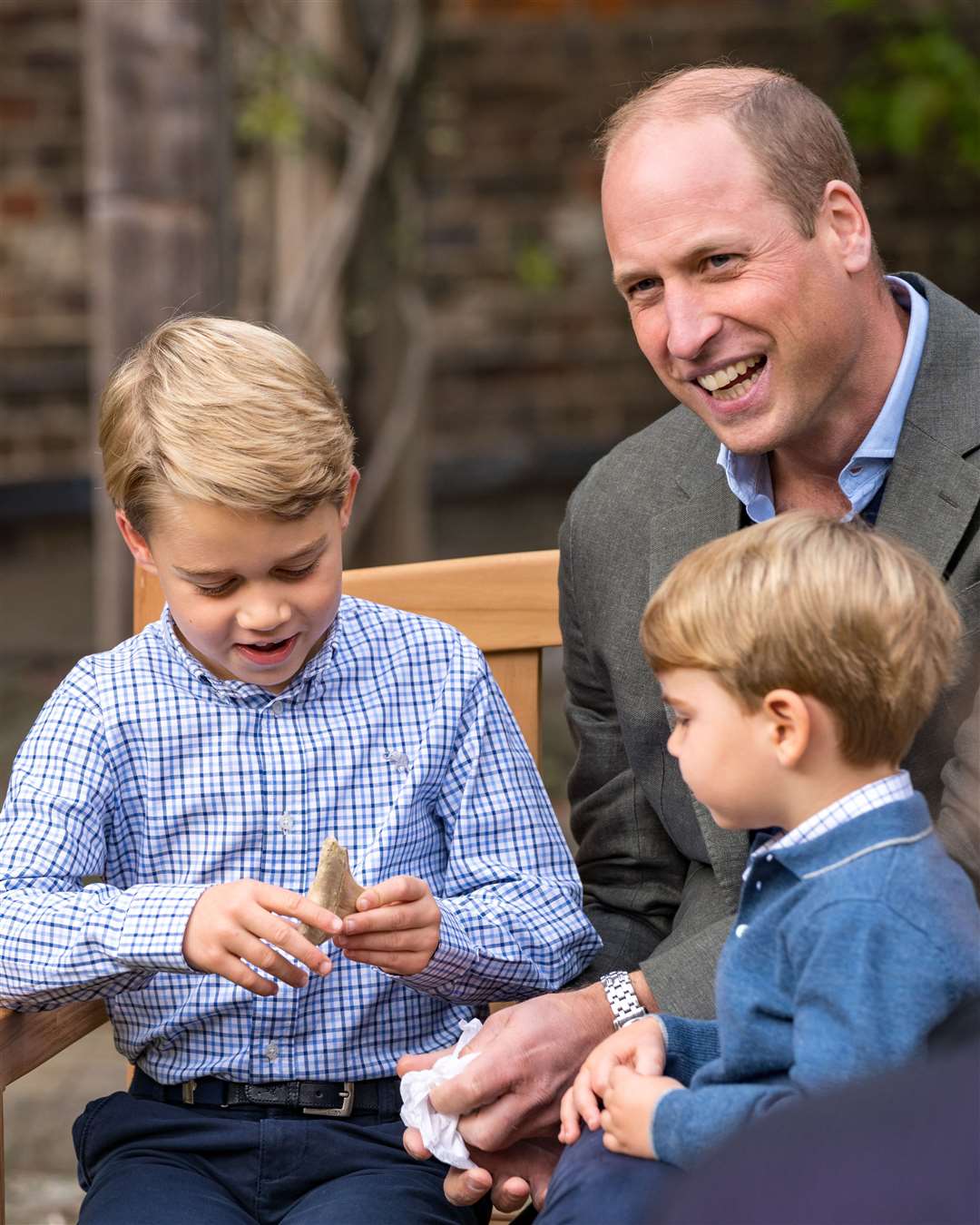 The Duke of Cambridge and Prince Louis watch as Prince George holds the tooth of a giant shark (Kensington Palace)