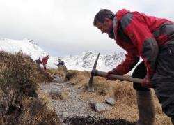 Donald Kennedy uses the mattock to clear a water bar.