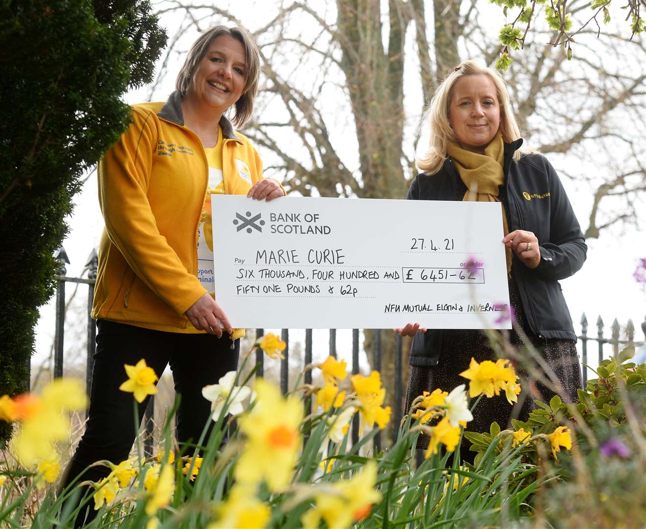 Vonnie Stevenson of Marie Curie accepts the donation from Rachael Snody-Scott of NFU Mutual Insurance. Picture: Gary Anthony..