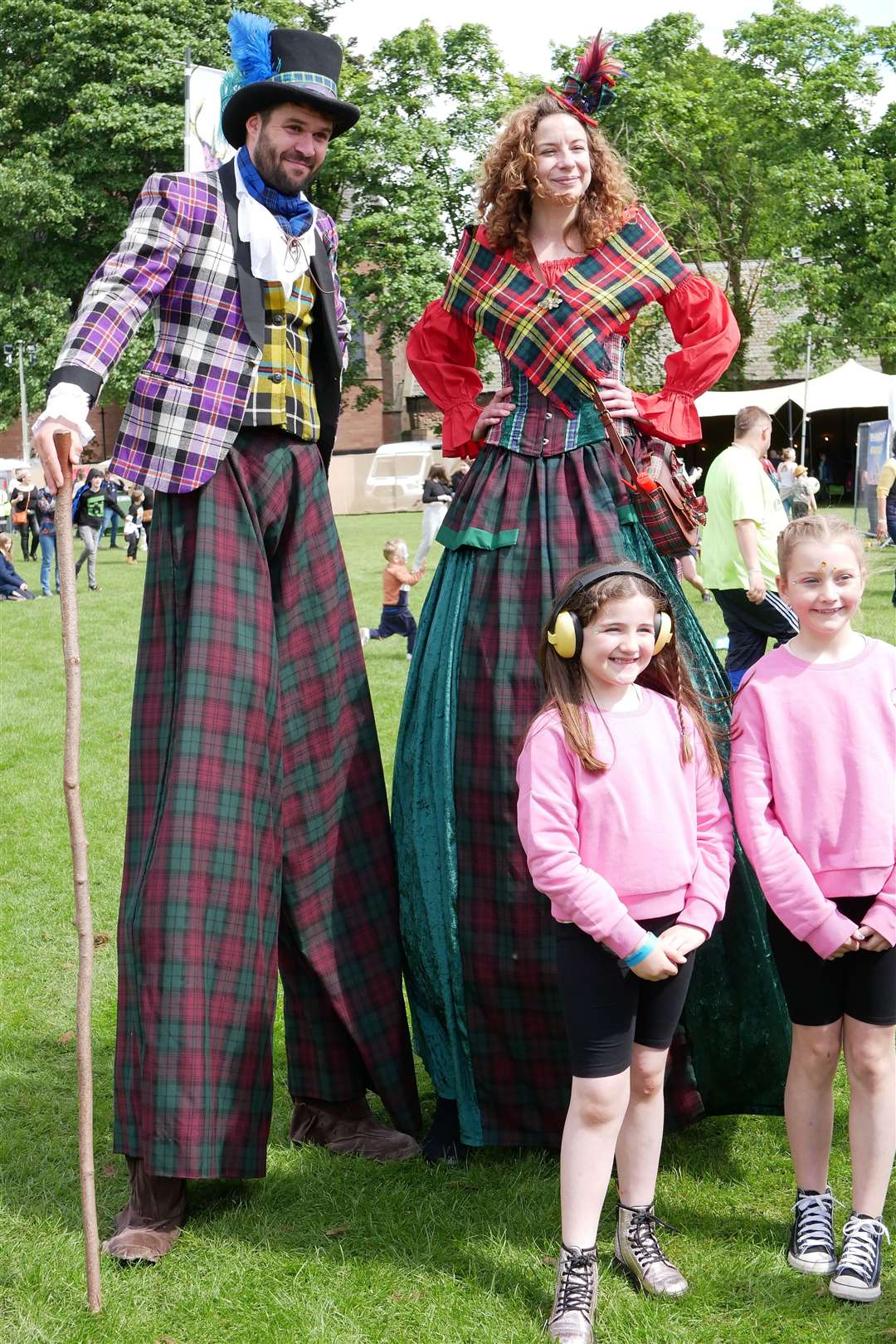 Stilt walkers Daniel Fitzsimmons and Emma Robbie from Fly Agaric with seven-year-old Jessica McCaffrey and nine-year-old Anna Dodds from Fort William.