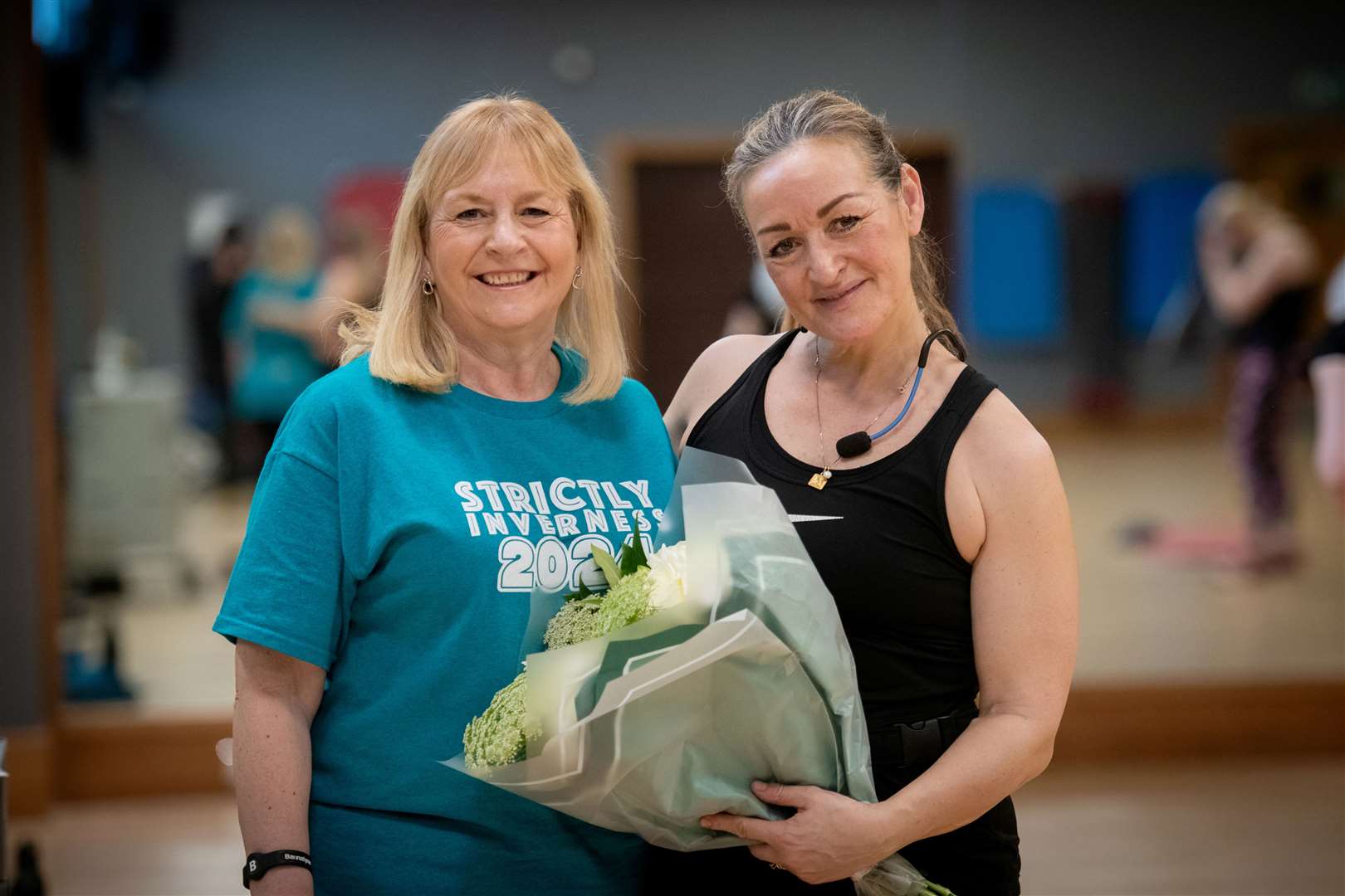 Event organiser Jackie Sutherland gives flowers to fitness instructor Marion Liddel in appreciation of Bannantyne's assistance. Picture: Callum Mackay.