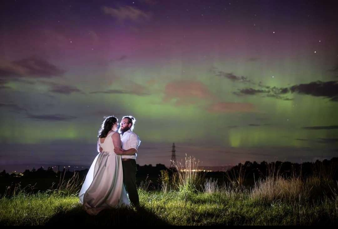 Newly weds pictured under incredible Northern lights. Picture: Michael Carver