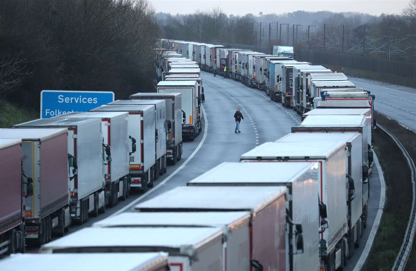 Lorry drivers walk about on the M20 in Kent, where freight traffic is parked up (Andrew Matthews/PA)