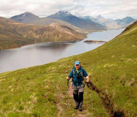 Heading up the stalking track to Spidean Mialach with Loch Quoich in the background.