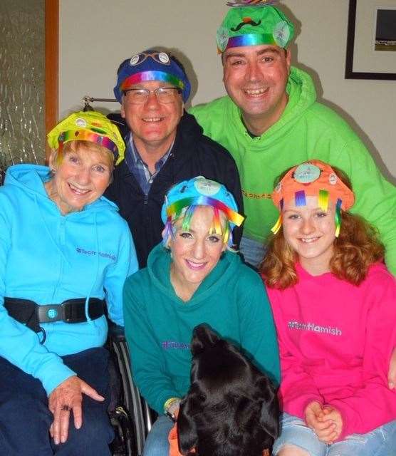 Susan Hey with her parents and her husband Sam pose with their daughter Lily wearing pants on their head in prepapration for Run for Hamish.
