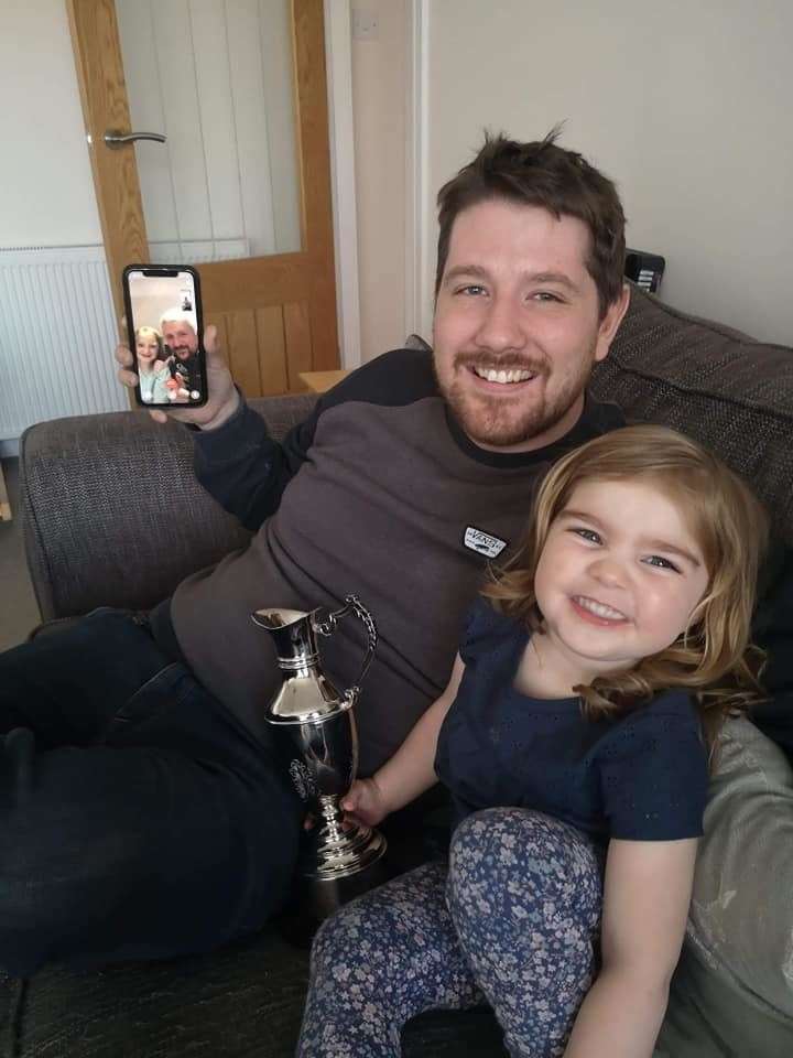 Keir Beaton is presented with his award from daughter Mae with brother Paul on FaceTime.