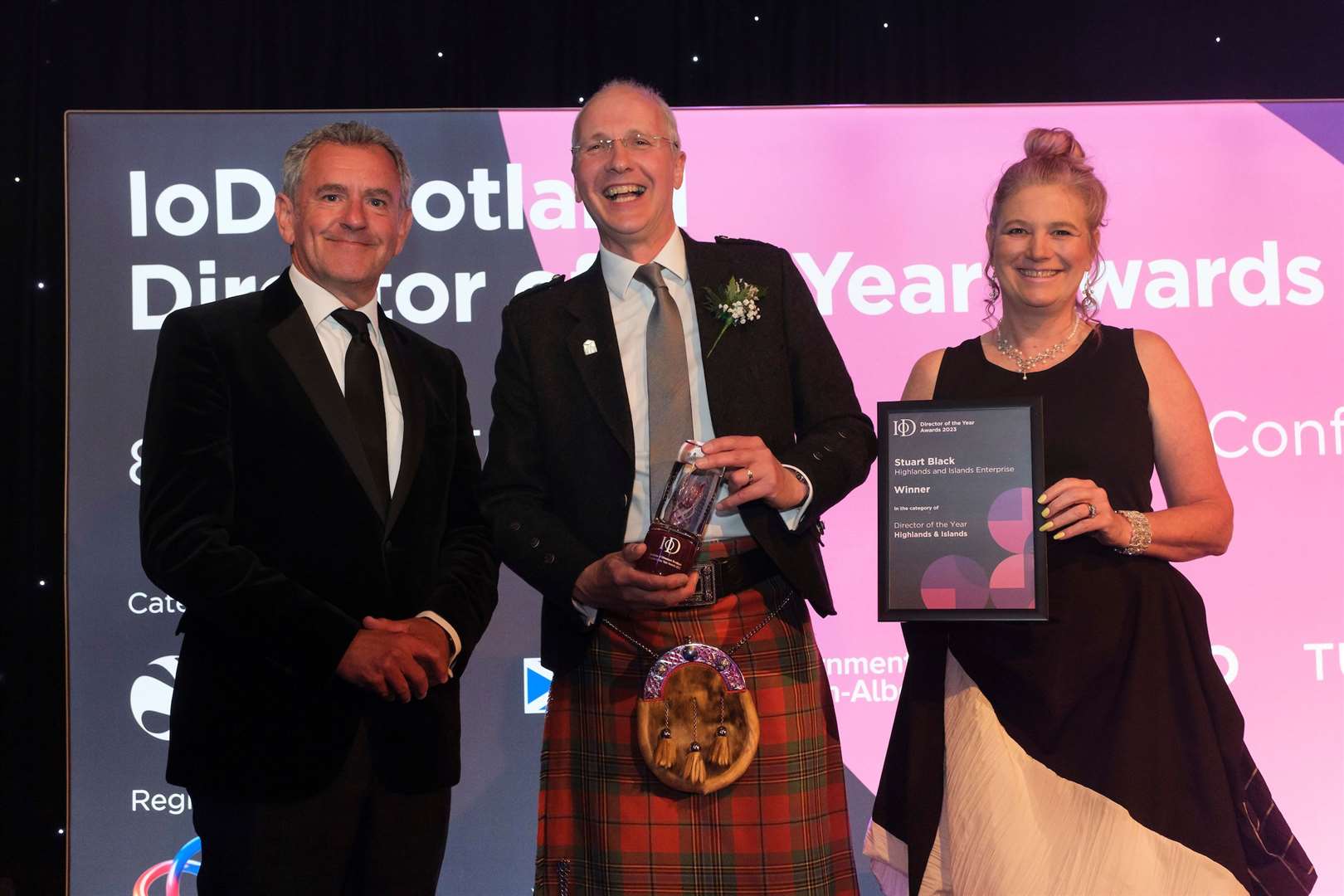 Stuart Black receiving the award presented by Julie Ashworth, chairwoman of Institute of Directors Scotland, alongside broadcaster and presenter of the ceremony Stephen Jardine.