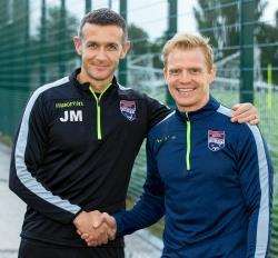 Ross County manager Jim McIntyre welcomes Chris Burke to Dingwall.
