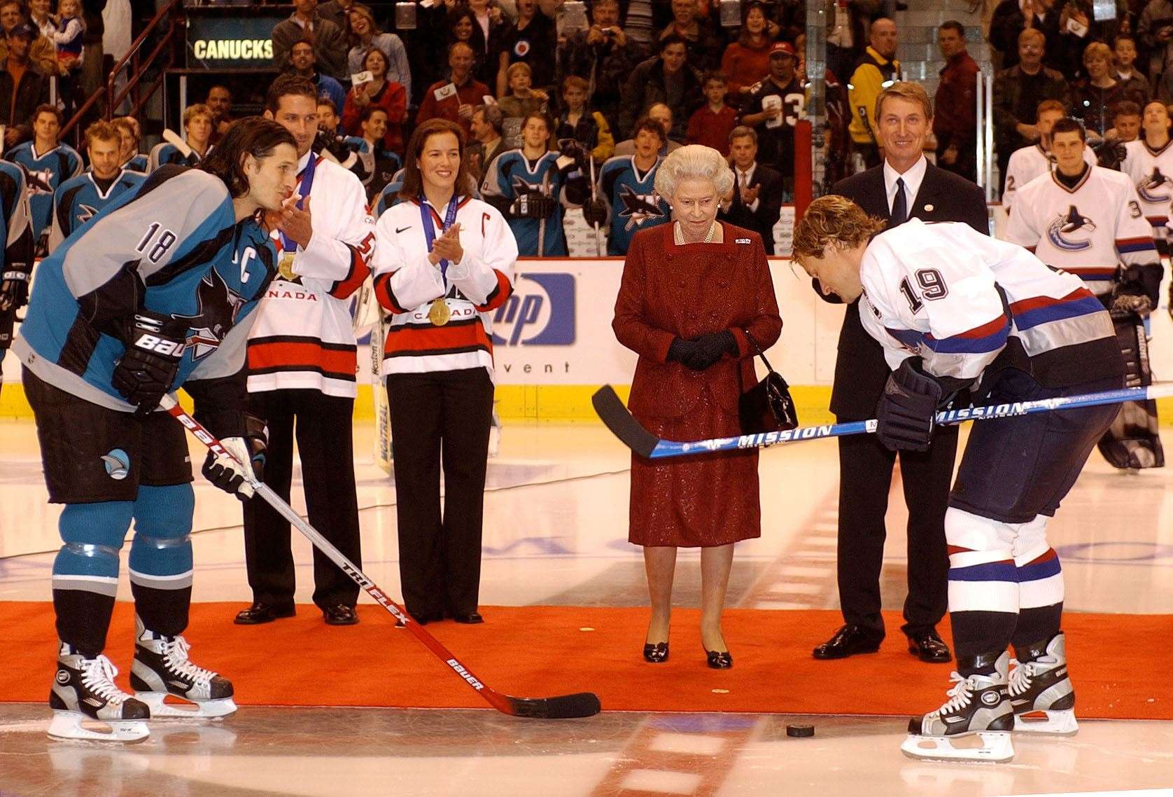 Queen Elizabeth II starts an ice hockey game between San Jose Sharks and Vancouver Canucks during her two-week Golden Jubilee tour of Canada (Kirsty Wigglesworth/PA)