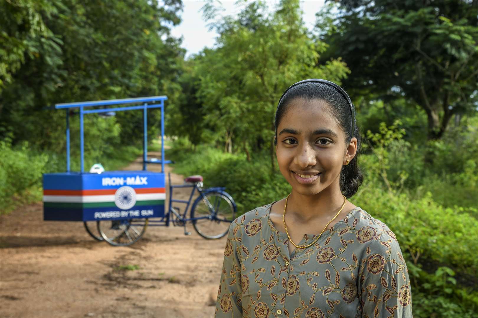 Vinisha Umashankar with the solar-powered ironing cart she designed (Earthshot Prize/PA)