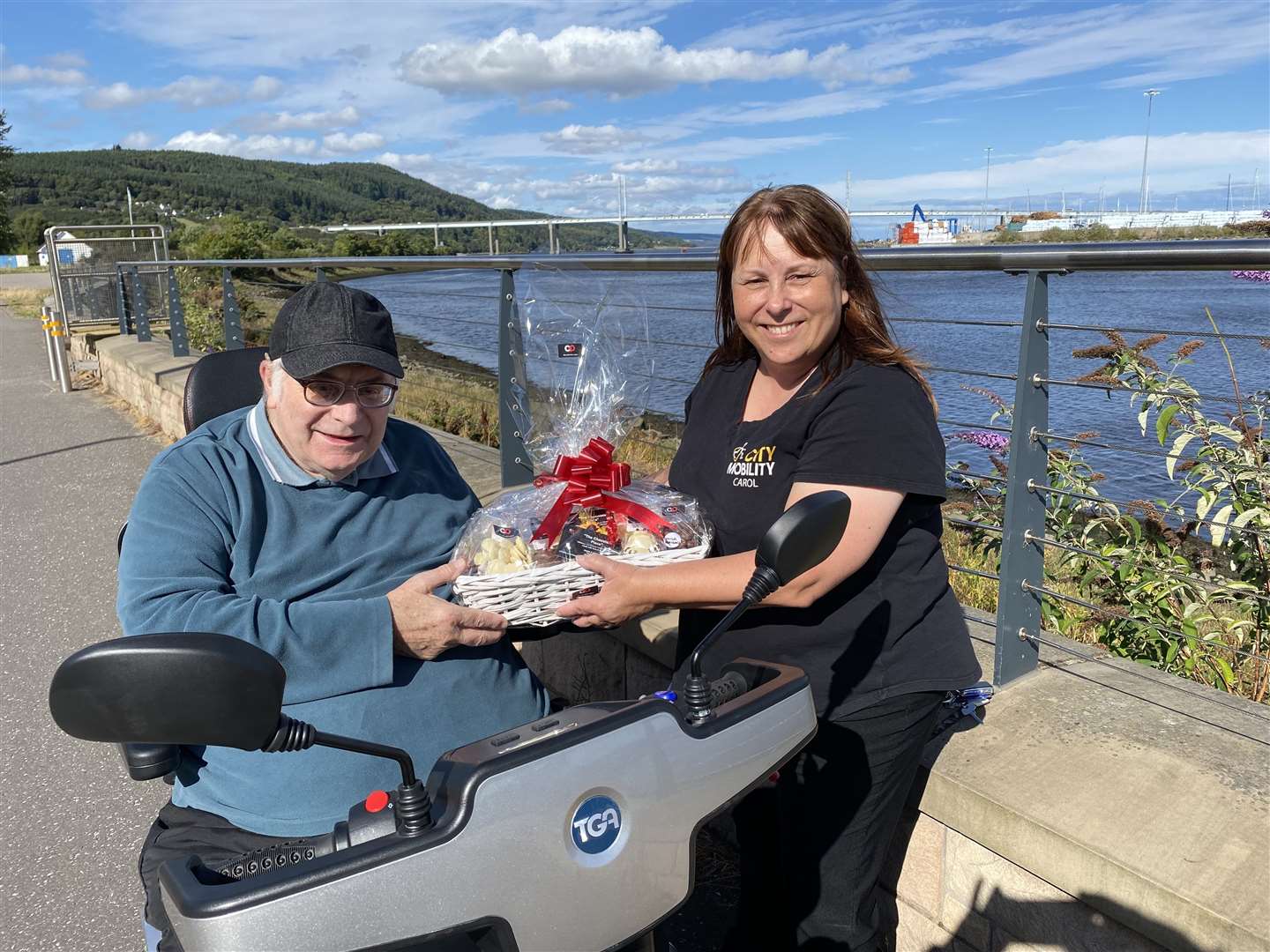 Brian taking delivery of his next new scooter and a thank you chocolate hamper sourced locally from “The Chocolate Place” from City Mobility for being itslongest serving Motability customer.