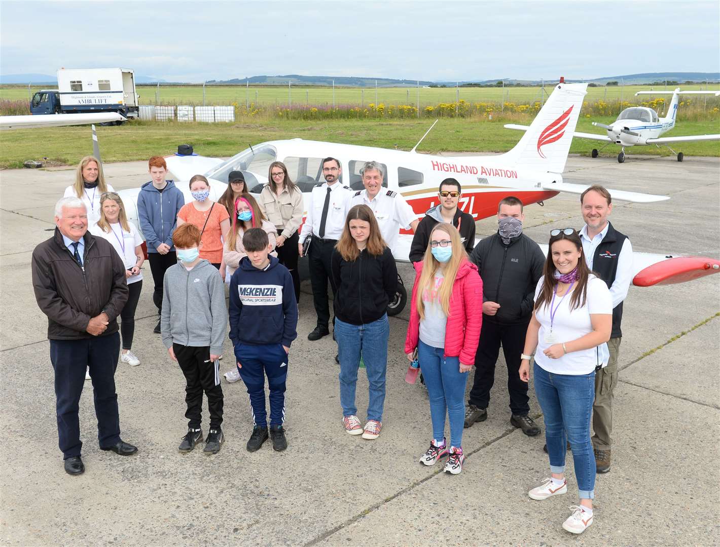 Highland Aviation give Young Carers a flight thanks to grant from Honourable Company of Air Pilots.Young carers and Highland Aviation staff with Alasdair Beaton of Honourable Company of Air Pilots(left). Picture Gary Anthony.