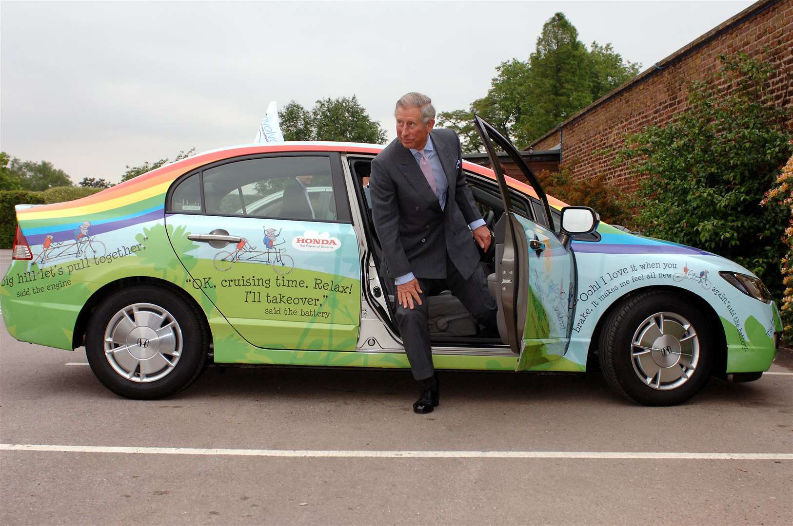 He took an eco-friendly Honda Civic for a test drive around the car park of Hampton Court Palace (PA)