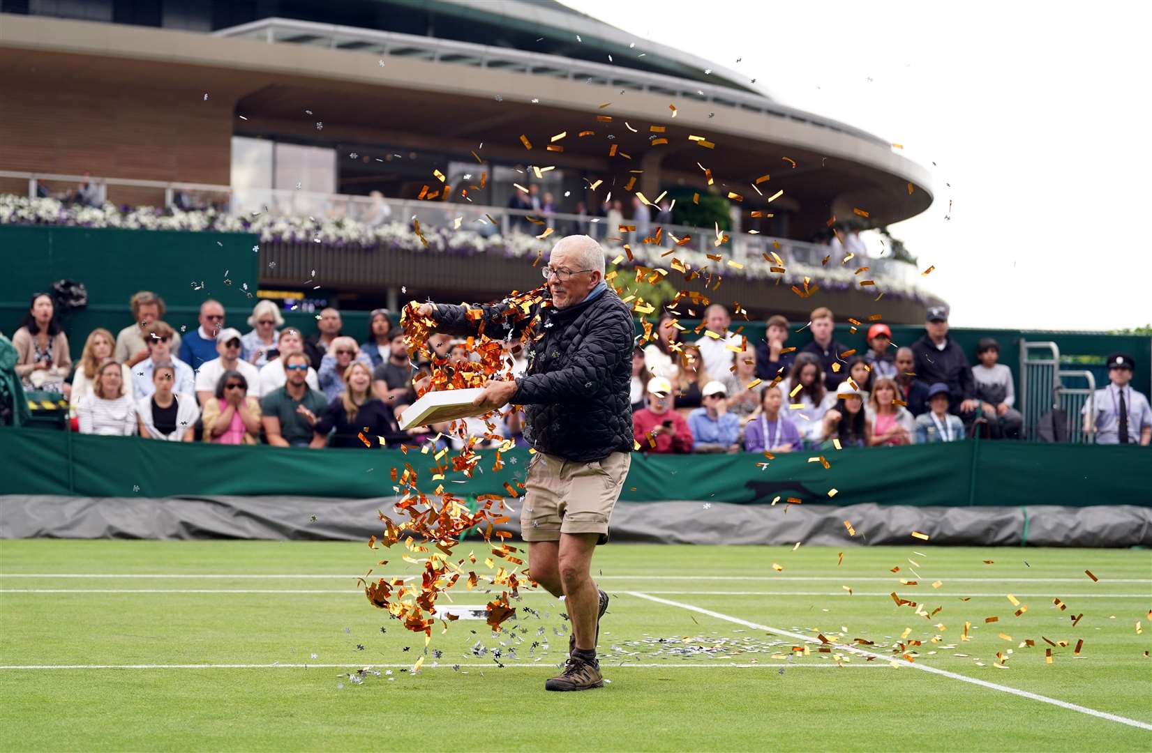 William Ward on Court 18 throwing confetti on the grass (Adam Davy/PA)